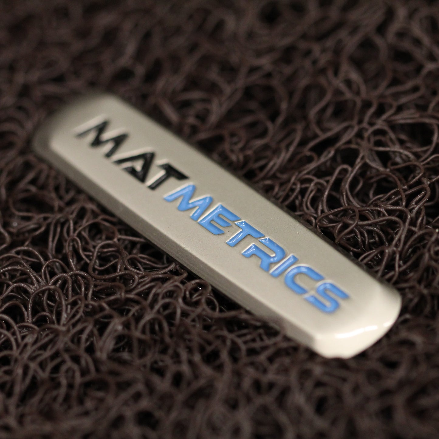 Close-up of Mat Metrics logo batch on the Brown Detachable Vinyl Insert